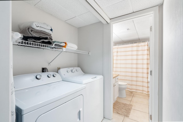 11483 Front Beach Rd Unit 202, Panama City Beach, FL 32407 - washroom featuring washing machine and dryer and light tile patterned floors