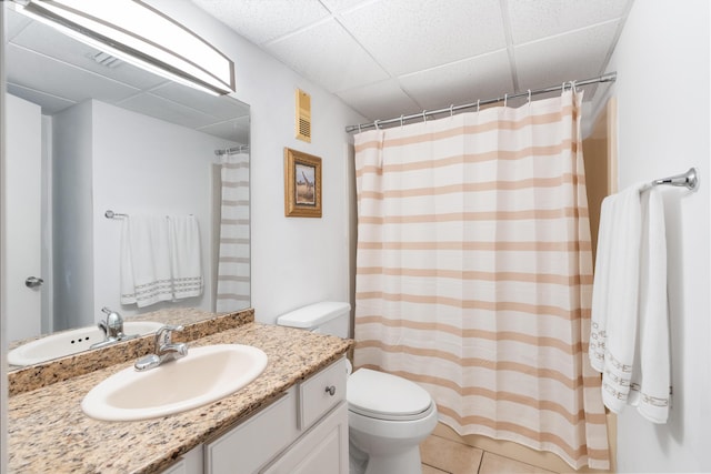 11483 Front Beach Rd Unit 202, Panama City Beach, FL 32407 - bathroom featuring toilet, a drop ceiling, vanity, tile patterned floors, and curtained shower