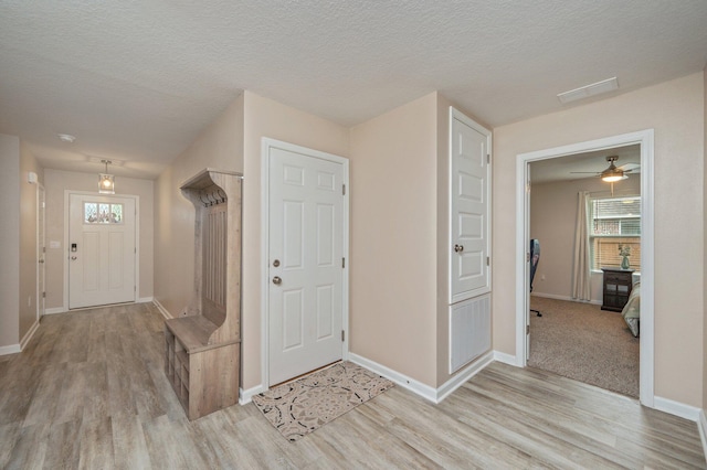 5378 Wyndell Cir, Crestview, FL 32539 - entrance foyer with light wood-style floors, baseboards, healthy amount of natural light, and a textured ceiling