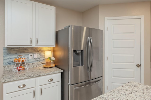 5378 Wyndell Cir, Crestview, FL 32539 - kitchen featuring stainless steel fridge, tasteful backsplash, white cabinets, and light stone counters