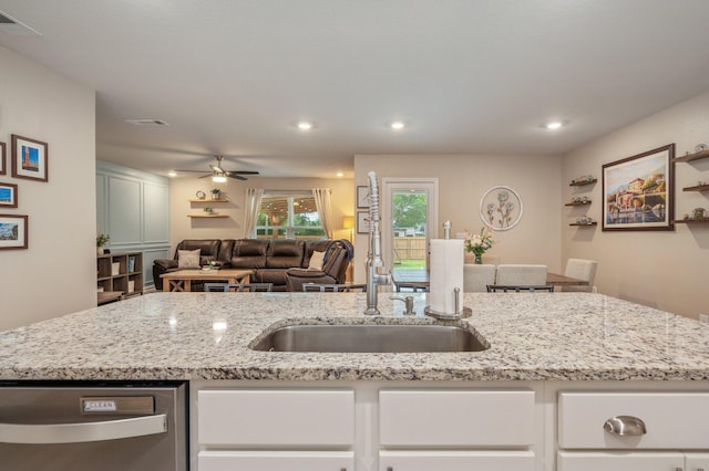 5378 Wyndell Cir, Crestview, FL 32539 - kitchen featuring open floor plan, stainless steel dishwasher, light stone counters, a sink, and ceiling fan