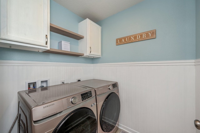5378 Wyndell Cir, Crestview, FL 32539 - laundry area with cabinet space, washer and clothes dryer, and wainscoting