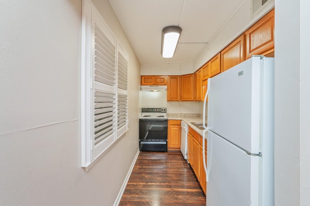 209 W Miracle Strip Pkwy Unit C 202, Mary Esther, FL 32569 - kitchen with white appliances, under cabinet range hood, dark wood-style flooring, light countertops, and decorative backsplash