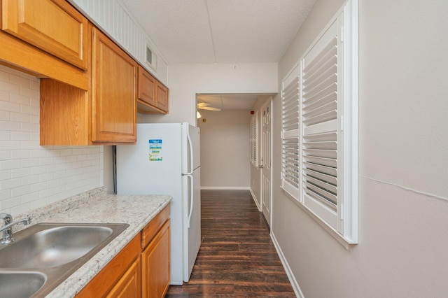 209 W Miracle Strip Pkwy Unit C 202, Mary Esther, FL 32569 - kitchen featuring freestanding refrigerator, a sink, dark wood finished floors, backsplash, and a textured ceiling