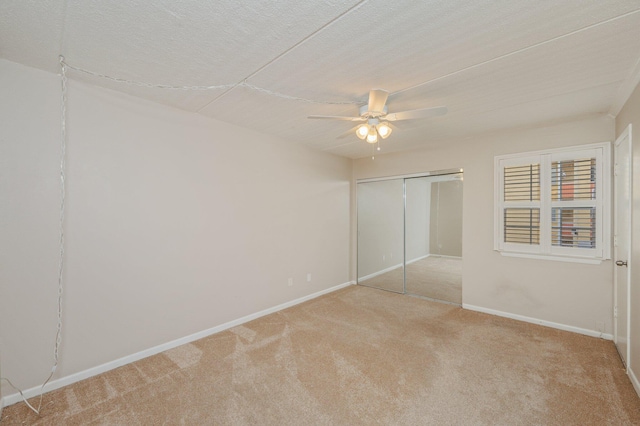 209 W Miracle Strip Pkwy Unit C 202, Mary Esther, FL 32569 - unfurnished bedroom with light colored carpet, a closet, baseboards, and a ceiling fan
