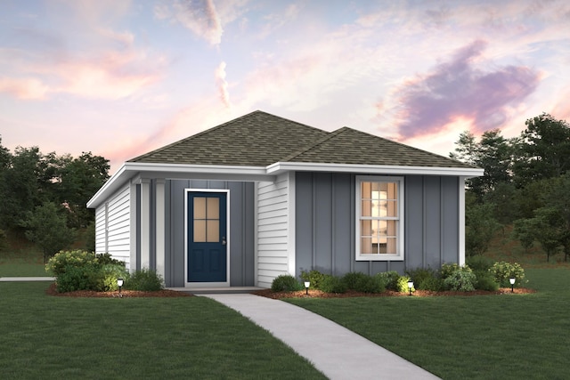 106 E Iris Ln, Defuniak Springs, FL 32433 - view of front of house featuring board and batten siding, a front lawn, and roof with shingles