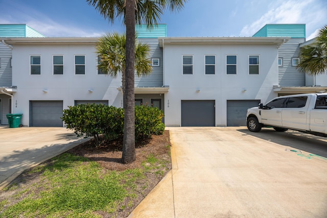 340 Bluefish Dr Unit 106, Fort Walton Beach, FL 32548 - view of property with driveway, stucco siding, and an attached garage