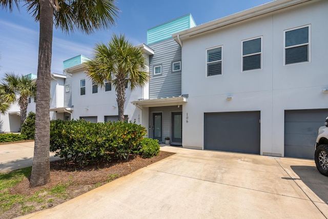 340 Bluefish Dr Unit 106, Fort Walton Beach, FL 32548 - townhome / multi-family property with an attached garage, stucco siding, and driveway