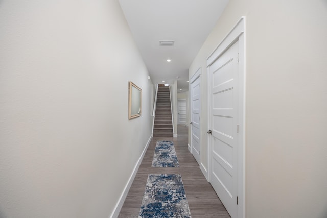 340 Bluefish Dr Unit 106, Fort Walton Beach, FL 32548 - hallway featuring baseboards, wood finished floors, recessed lighting, and stairway