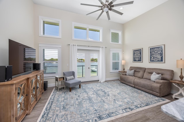 340 Bluefish Dr Unit 106, Fort Walton Beach, FL 32548 - living room with a ceiling fan, a high ceiling, baseboards, french doors, and wood finished floors