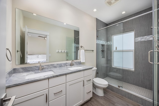 340 Bluefish Dr Unit 106, Fort Walton Beach, FL 32548 - full bath featuring double vanity, wood finished floors, connected bathroom, toilet, and a shower stall