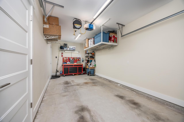 340 Bluefish Dr Unit 106, Fort Walton Beach, FL 32548 - garage featuring a workshop area, a garage door opener, and baseboards
