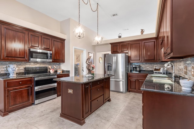 6202 Plum Orchard Way, Crestview, FL 32536 - kitchen with appliances with stainless steel finishes, a sink, tasteful backsplash, dark stone counters, and light tile patterned flooring