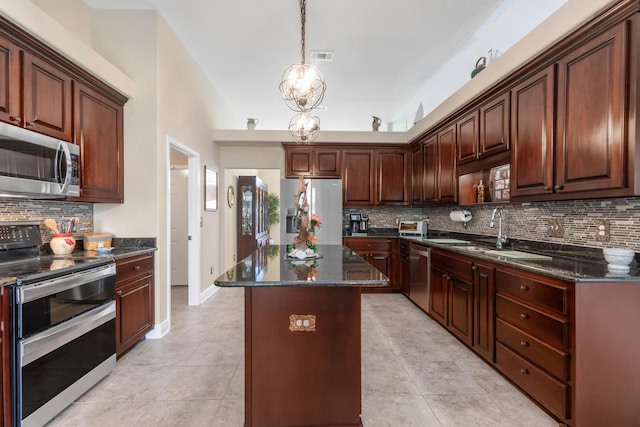 6202 Plum Orchard Way, Crestview, FL 32536 - kitchen with appliances with stainless steel finishes, a sink, decorative backsplash, a center island, and light tile patterned floors