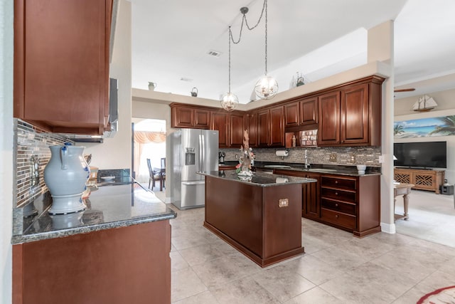 6202 Plum Orchard Way, Crestview, FL 32536 - kitchen featuring stainless steel fridge with ice dispenser, tasteful backsplash, a center island, dark stone countertops, and pendant lighting