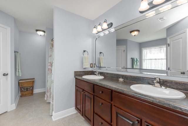 6202 Plum Orchard Way, Crestview, FL 32536 - full bathroom featuring double vanity, tile patterned floors, and baseboards