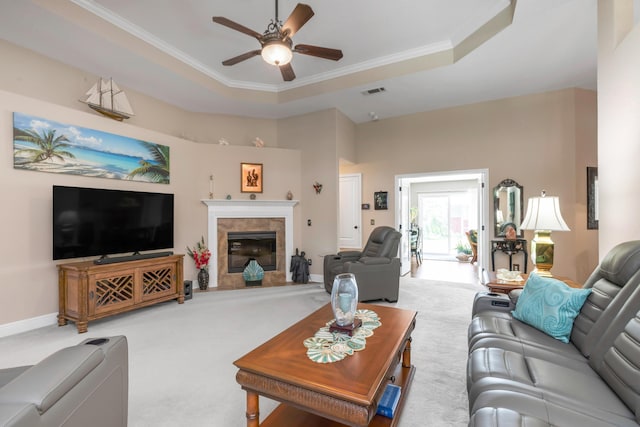 6202 Plum Orchard Way, Crestview, FL 32536 - carpeted living area with ornamental molding, a ceiling fan, a tile fireplace, baseboards, and a tray ceiling