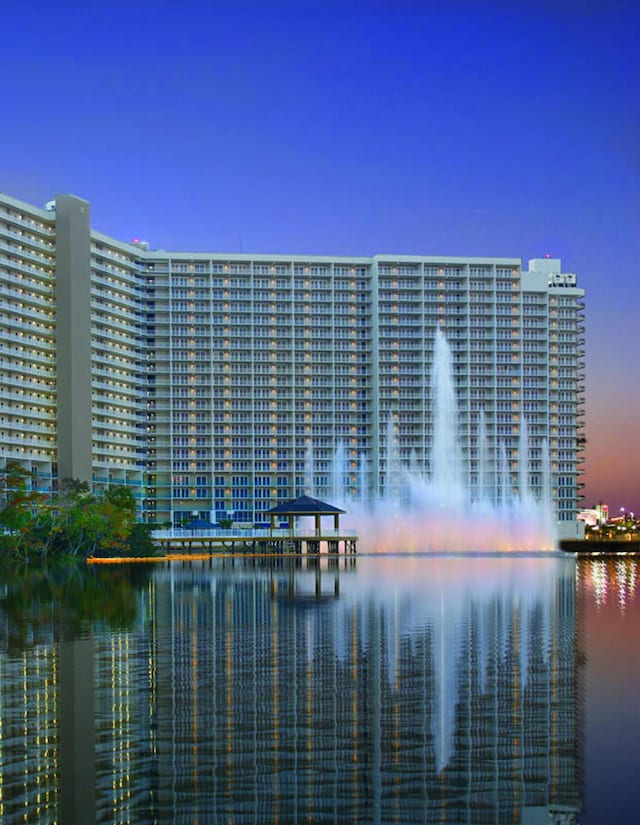 9860 S Thomas Dr Unit 726, Panama City Beach, FL 32408 - property at dusk featuring a water view