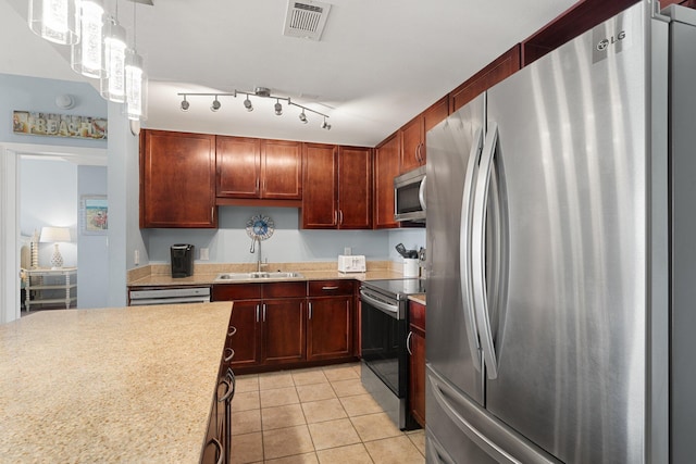 9860 S Thomas Dr Unit 726, Panama City Beach, FL 32408 - kitchen featuring appliances with stainless steel finishes, a sink, light countertops, light tile patterned flooring, and pendant lighting
