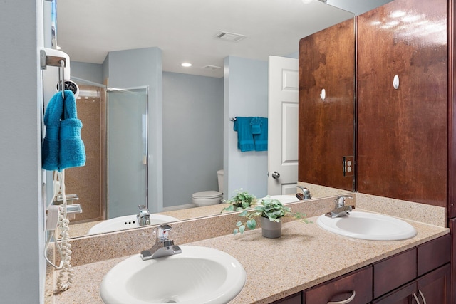 9860 S Thomas Dr Unit 726, Panama City Beach, FL 32408 - bathroom featuring double vanity, toilet, and a shower with door