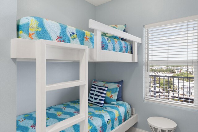 9860 S Thomas Dr Unit 726, Panama City Beach, FL 32408 - bedroom with multiple windows and baseboards
