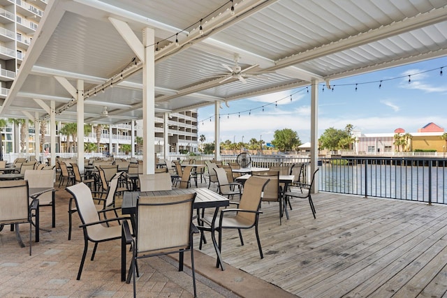 9860 S Thomas Dr Unit 726, Panama City Beach, FL 32408 - wooden terrace with a ceiling fan, a water view, and outdoor dining area