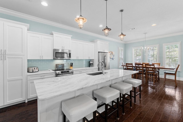 41 Bentley Ln, Santa Rosa Beach, FL 32459 - kitchen featuring stainless steel appliances, a sink, an island with sink, tasteful backsplash, and white cabinetry