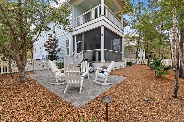 41 Bentley Ln, Santa Rosa Beach, FL 32459 - fenced backyard with a balcony, a sunroom, a patio area, and a gate