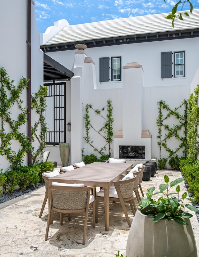 25 Moongate Ct, Inlet Beach, FL 32461 - view of patio / terrace featuring exterior fireplace and outdoor dining space