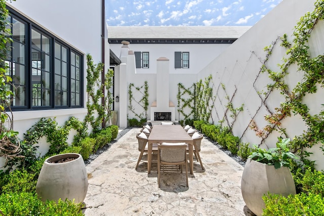 25 Moongate Ct, Inlet Beach, FL 32461 - view of patio featuring outdoor dining area and an outdoor fireplace