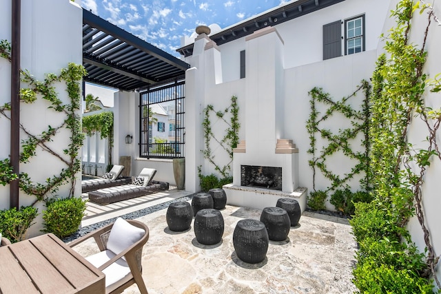 25 Moongate Ct, Inlet Beach, FL 32461 - view of patio / terrace with an outdoor fireplace