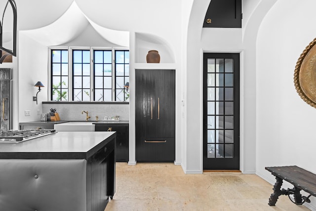 25 Moongate Ct, Inlet Beach, FL 32461 - kitchen with a sink, dark cabinets, stainless steel gas stovetop, and decorative backsplash