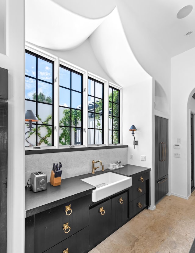 25 Moongate Ct, Inlet Beach, FL 32461 - kitchen with a sink, dark countertops, dark cabinets, and decorative backsplash