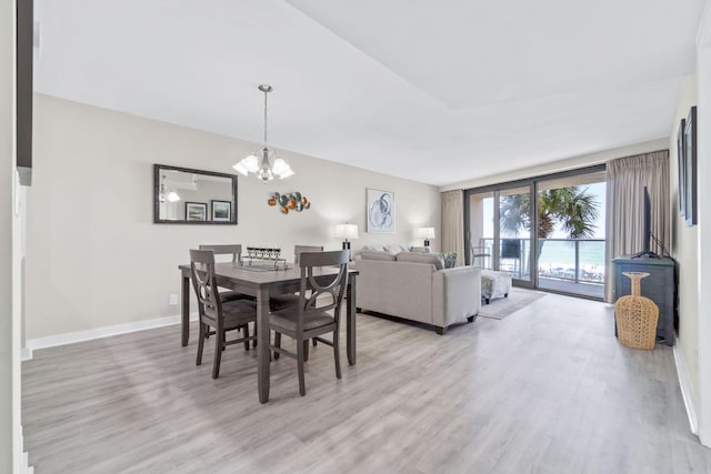 4228 Beachside Two # 228, Miramar Beach, FL 32550 - dining room with light wood-type flooring, a chandelier, and baseboards