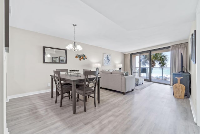 4228 Beachside Two # 228, Miramar Beach, FL 32550 - dining room featuring light wood finished floors, a chandelier, and baseboards
