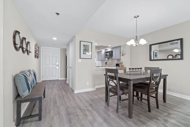 4228 Beachside Two # 228, Miramar Beach, FL 32550 - dining room featuring light wood-style floors, a chandelier, baseboards, and recessed lighting