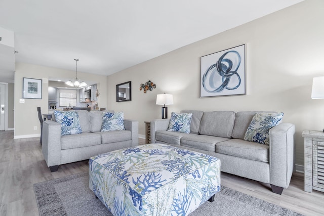 4228 Beachside Two # 228, Miramar Beach, FL 32550 - living room featuring a chandelier, wood finished floors, and baseboards