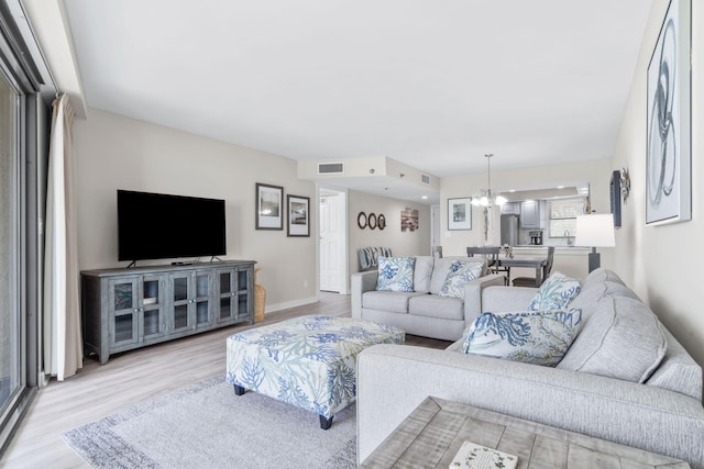 4228 Beachside Two # 228, Miramar Beach, FL 32550 - living room with light wood-style flooring, a chandelier, and baseboards
