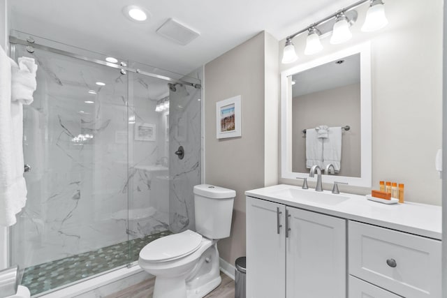 4228 Beachside Two # 228, Miramar Beach, FL 32550 - full bath with toilet, a marble finish shower, vanity, and wood finished floors