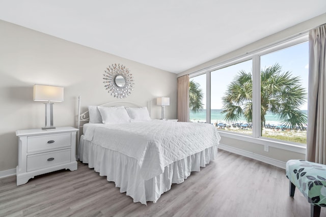4228 Beachside Two # 228, Miramar Beach, FL 32550 - bedroom with light wood-type flooring, baseboards, and a water view