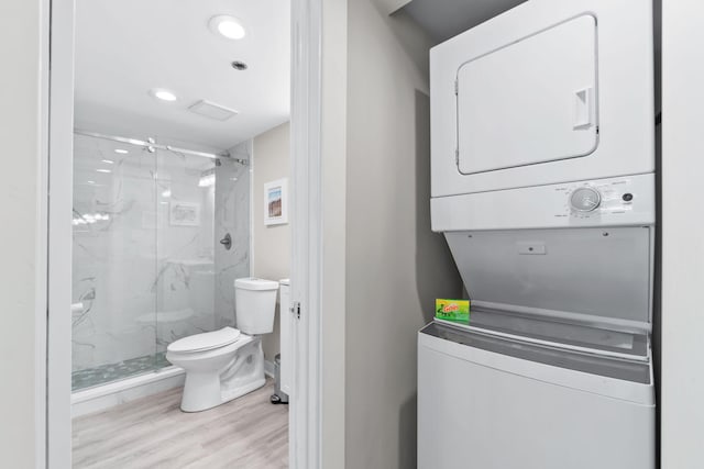 4228 Beachside Two # 228, Miramar Beach, FL 32550 - laundry room with estacked washer and dryer, wood finished floors, and recessed lighting