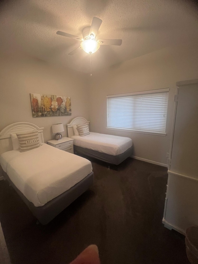 9011 W US Highway 98 # A-601, Miramar Beach, FL 32550 - bedroom featuring dark colored carpet, ceiling fan, a textured ceiling, and baseboards