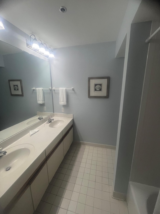 9011 W US Highway 98 # A-601, Miramar Beach, FL 32550 - full bathroom featuring tile patterned flooring, double vanity, a shower, a tub to relax in, and baseboards