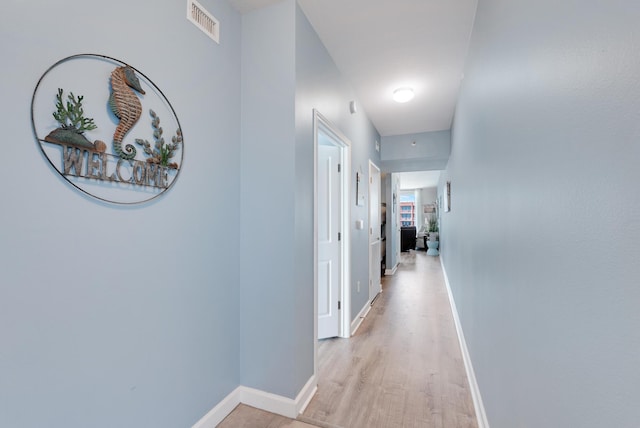 9900 S Thomas Dr Unit 2226, Panama City Beach, FL 32408 - hall featuring baseboards and light wood finished floors