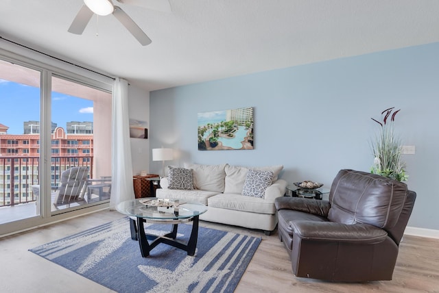 9900 S Thomas Dr Unit 2226, Panama City Beach, FL 32408 - living room featuring healthy amount of natural light, a ceiling fan, light wood-type flooring, and a city view