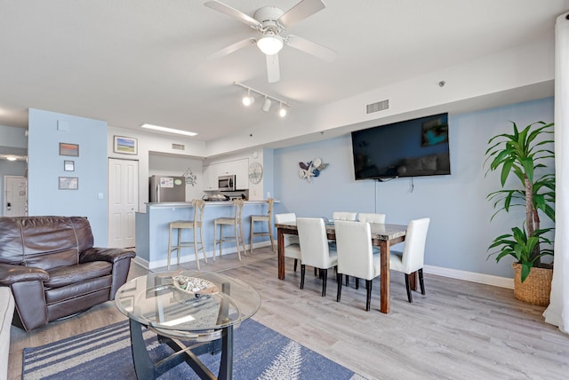 9900 S Thomas Dr Unit 2226, Panama City Beach, FL 32408 - living room featuring track lighting, light wood finished floors, a ceiling fan, and baseboards