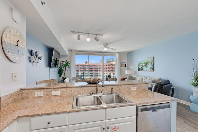 9900 S Thomas Dr Unit 2226, Panama City Beach, FL 32408 - kitchen with dishwasher, a sink, open floor plan, light wood-style flooring, and a ceiling fan