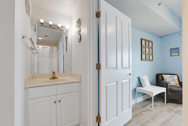 9900 S Thomas Dr Unit 2226, Panama City Beach, FL 32408 - full bathroom featuring vanity, wood finished floors, and a shower with shower curtain