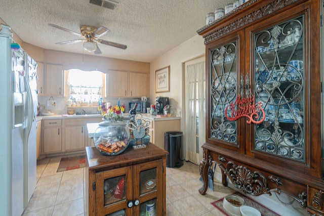 2522 Lake Silver Rd, Crestview, FL 32536 - kitchen featuring white refrigerator with ice dispenser, light countertops, light brown cabinets, a ceiling fan, and a sink