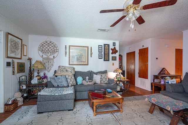 2522 Lake Silver Rd, Crestview, FL 32536 - living room featuring wood finished floors, a ceiling fan, and a textured ceiling